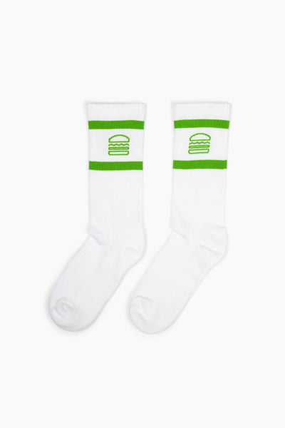 White socks with the Shake Shack logo between two green stripes